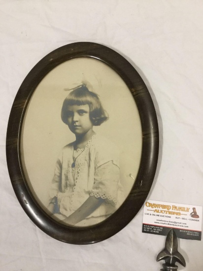 Antique oval picture frame with a portrait of a young girl, approximately 10.5 x 13.5 inches.