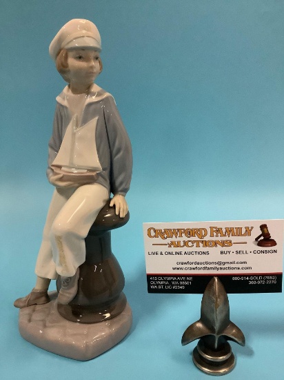 Lladro figurine of boy sitting on dock w/ toy sailboat , hand made in Spain, approx. 4 x 9.5 in.