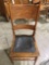 Vintage wood carved chair w/ 2 leather seat attachments, sold as is.
