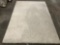 Shag carpet, off white, approx 73 x 109 in. Shows minor wear.