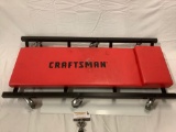 Craftsman creeper, approx 35 x 17 x 4 in. Shows wear on cushion.