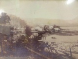 Framed vintage photograph of logging town on bay, approximately 11 x 9.5 in.