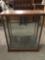 Vintage wood sliding glass door display case w/ 3 glass shelves, missing brackets. Sold as is.