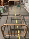 Vintage metal twin bed frame on wheels, approx 80 x 39 x 50 in.