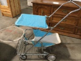 Vintage childrens baby stroller, blue vinyl, metal frame, shows wear