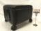 Small black rolling ottoman footstool with storage, approx 14 x 12 x 11 in.