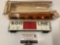 Vintage TYCO HO scale electric toy train car w/ worn packaging, approx 9 x 2 x 1 in.