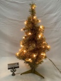 Small decorative Christmas tree with yellow lights, tested and working, approximately 12 by 24 in.