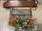 Modern metal frame display table w/ 2 faux flower arrangement hanging baskets, approx 31 x 14 30 in.