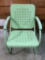 green painted metal patio chair, shows wear.