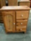 Wooden three drawer cabinet with cupboard, approx 23 x 12 x 29 in.