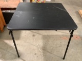 Black folding card table, approx 34 x 34 x 28 in.