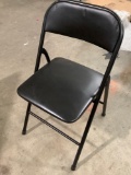 Black painted steel folding chair.