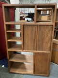 Large vintage wood entertainment center shelf unit with sliding wood door cabinet, shows wear,