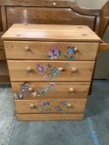 Wood 4 drawer dresser with floral applique design and towel bar, approx 30 x 16 x 34 in.