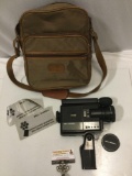 Vintage Bell and Howell film movie camera with lens and bag, sold as is.