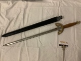 Vintage wood /brass handled sword/saber w/ sheath, approx 35 x 5 in. Marked: Pakistan