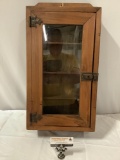Antique wood medicine cabinet with glass window door, approx 12 x 25 x 4 in.