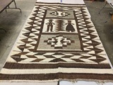 Vintage woven wool blanket with geometric male and female figure and bird design, approx 57 x 103