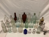 Large lot vintage vintage antique glass bottles, some branded, see pics.