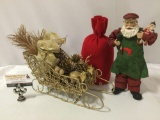 3 pc. lot of Christmas holiday decorations ; Santa Claus in toy workshop outfit, red bag, gold