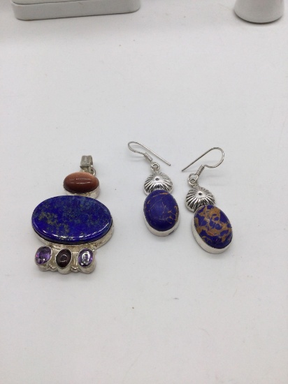 large silver marked .925 pendant and earrings with Blueish brown colored stones.