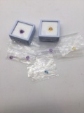 Nice selection of gems look like amethyst, citrine, and blue topaz