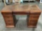 Vintage wood desk w/ leather top pieces, 8 drawers, approx 50 x 22 x 31 in.