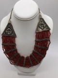 Vintage breast plate style necklace with coral colored beads and silver colored accents