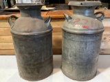 2 pc. lot of vintage steel milk canisters, 1 w/ branding, approx. 12 x 25 in.