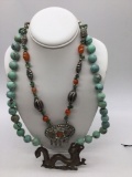 2 large Asian style necklaces one with turquoise beads and metal dragon, And 1 w/ multi stones