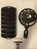 2 pc. lot if vintage cast iron kitchen items: cornbread pan marked 27 C, rooster design trivet