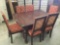 Antique oak dining table w/ carved legs, 6 matching cushioned chairs - chairs as is, see pics