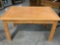 Pine wood desk table with one drawer, shows finish wear, approx 50 x 29 x 30 in.