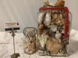 2 glass jars stuffed full of various seashells / starfish