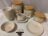 20 pc. lot of Corelle tableware plus 3 ceramic kitchen jars w/ wood lids, approx 8 x 9 in.