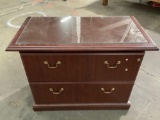 Large two drawer file cabinet with glass top piece, approx 40 x 21 x 30 in. Shows wear, sold as is.