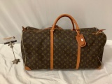 Authentic Louis Vuitton leather duffel bag, made in Paris France, approx 24 x 11 x 12 in.