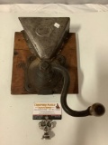 Antique hand crank coffee grinder mounted on wood, approx 15 x 8 x 7 in.