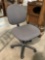 Rolling office chair w/ grey upholstery, approx 24 x 35 in.