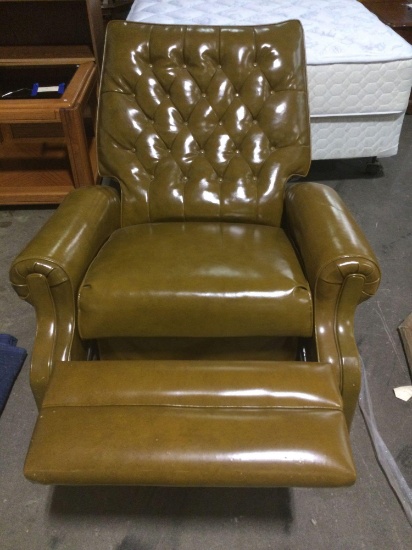 Circa late 1960 early 1973 green vinyl recliner with Rolling casters