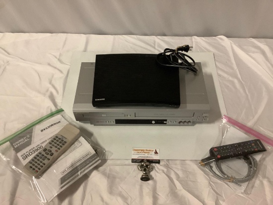 2 pc. lot: SAMSUNG Blu Ray Disc Player w/ remote, SYLVANIA DVD / VHS Player w/ remote, sold as is.