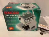 Singer Tiny Serger Overedging sewing Machine in box, appears unused, approx 12 x 8 x 9 in.