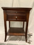 Wood nightstand with pull out surface and drawer, shows finish wear, approx 19 x 19 x 27 in.