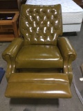 Circa late 1960 early 1973 green vinyl recliner with Rolling casters