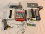 NINTENDO Wii video game console, controllers, manuals, cords, Super Mario Bros disc.