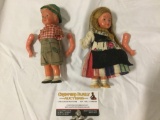 pair of vintage German boy & girl dolls w/ outfits, arms not attached, missing one arm, sold as is.