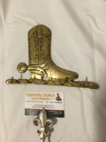 Vintage brass cowboy boot shaped wall hanger tie rack, approx 8 x 5 in.