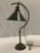 Antique copper desk lamp w/ green glass shade, approx. 12 x 23 in. Tested & working.