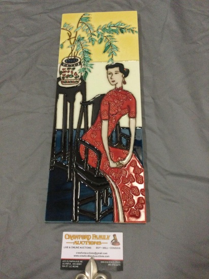 Chinese tile artwork of sitting woman in red dress, approx 6 x 16 in.